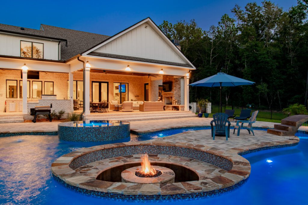 Close up of fire pit and seating area in the middle of a swimming pool - Cox pools